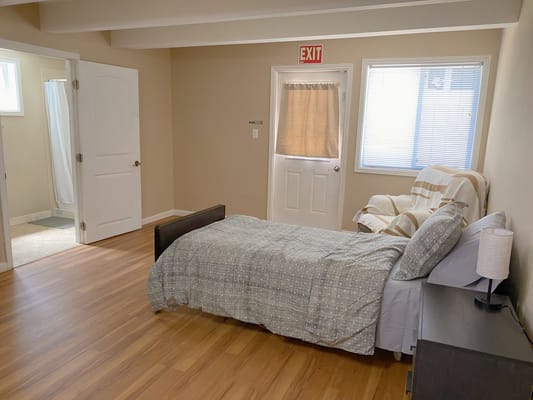 Cozy private resident room with a bed and chair