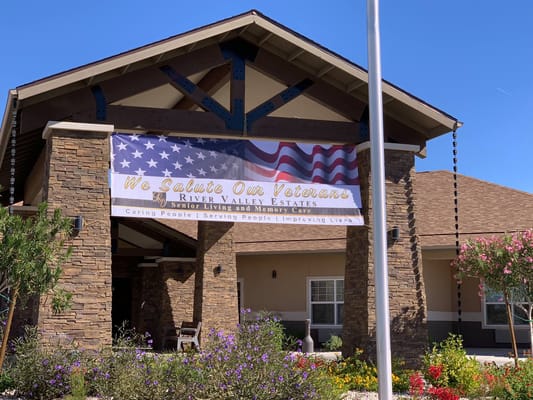 Exterior of River Valley Estates with veterans banner