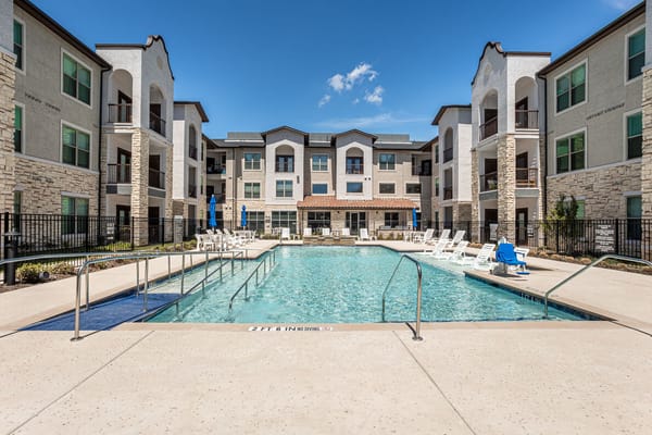 Outdoor pool area surrounded by the facility building