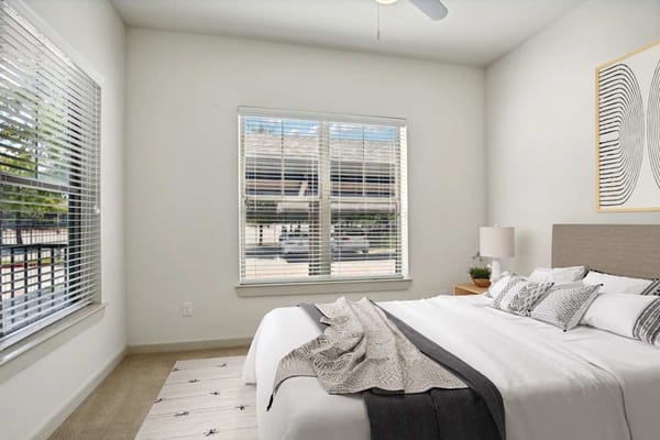 Well-furnished bedroom with natural light and view