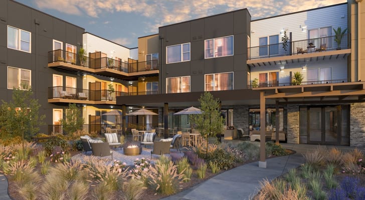 Outdoor seating area with fire pit at a senior living facility