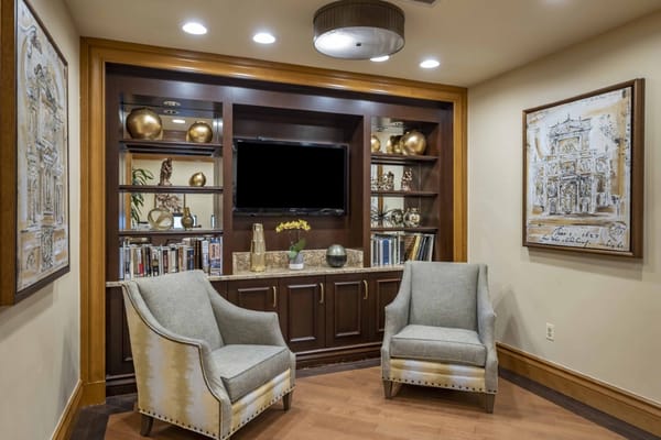 Cozy common area with comfortable chairs and decorative shelves