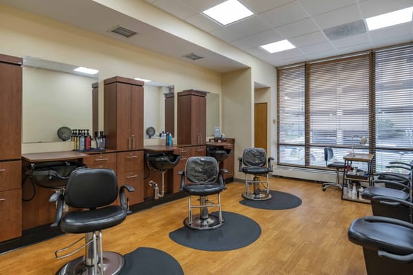Hair salon area with styling chairs and mirrors
