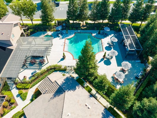 Aerial view of the outdoor pool area with chairs and umbrellas