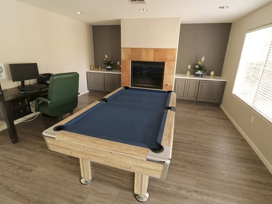Activity room with a pool table and fireplace