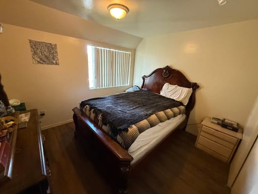 A cozy bedroom with a large wooden bed