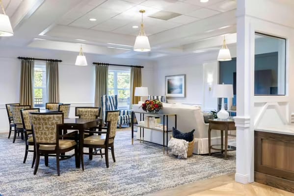 Bright common area with dining tables and comfortable seating