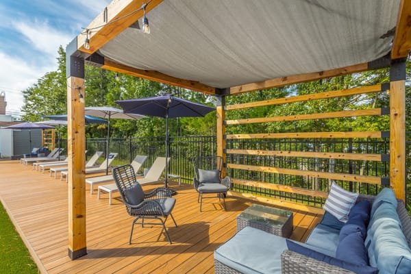 Outdoor seating area with loungers and shaded pergola