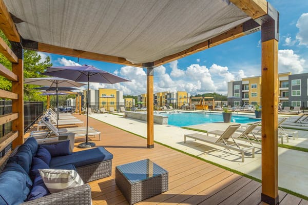 Pool area with lounge chairs and umbrellas