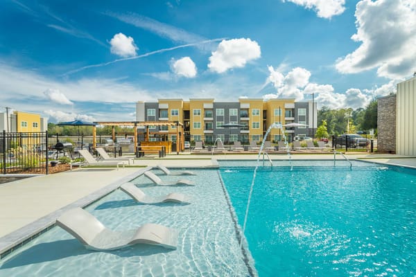 Outdoor swimming pool area with lounge chairs