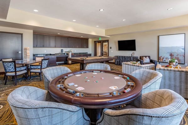 Bright common area with seating and a poker table