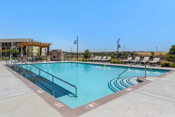 Outdoor swimming pool area with lounge chairs