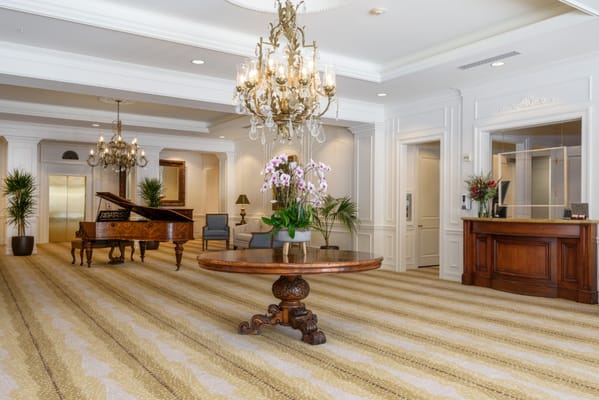 Elegant lobby with piano and floral arrangements
