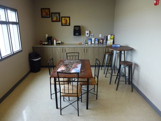 Bright common area with seating and a kitchenette