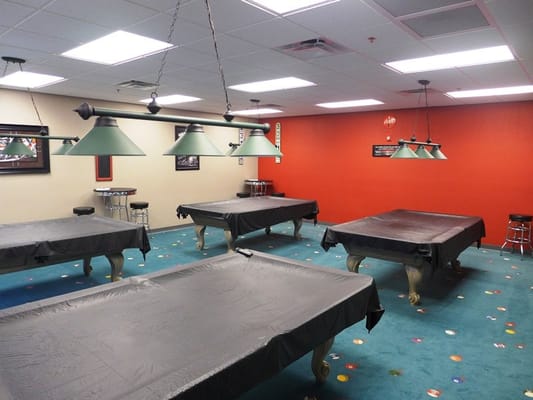 Interior view of a game room with pool tables