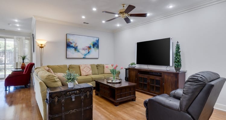 Comfortable living room with sofa, coffee table, and TV.