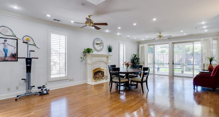 Bright living room with dining table and gym equipment