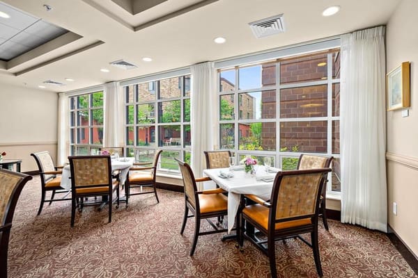 Bright dining area with tables and large windows