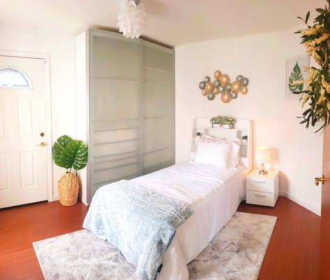 A bright, simple resident room with natural light