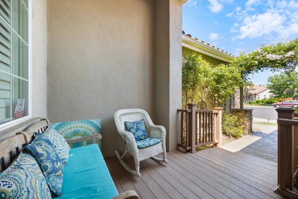 Outdoor seating area with a rocking chair and cushions