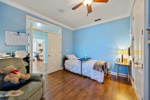 Cozy resident room with a bed and chair