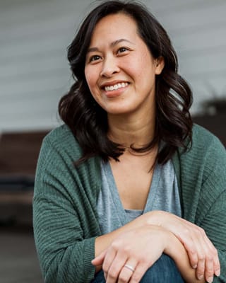 A smiling woman sitting in a casual setting