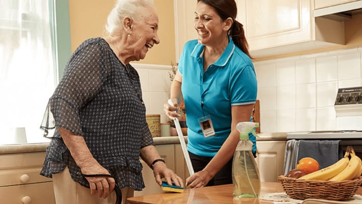 Caregiver assisting a resident in the kitchen