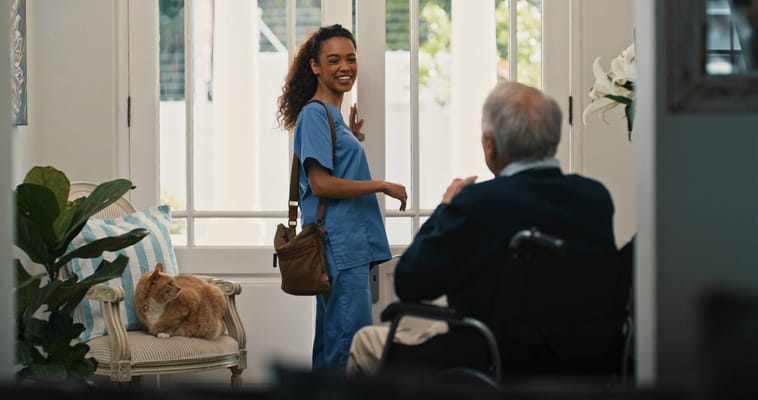 A caregiver interacting with a senior resident in a common area