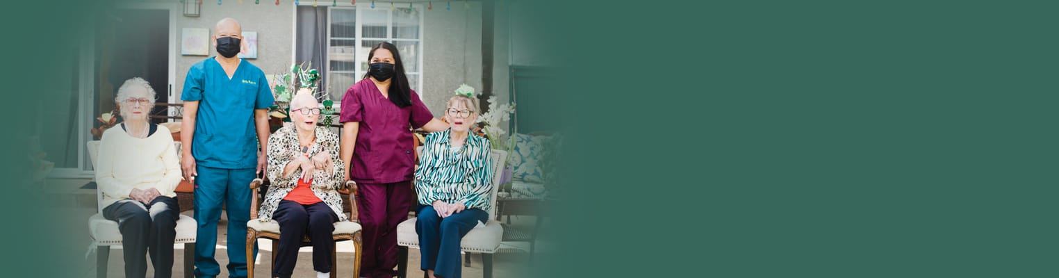 Group of staff and residents posing together in common area