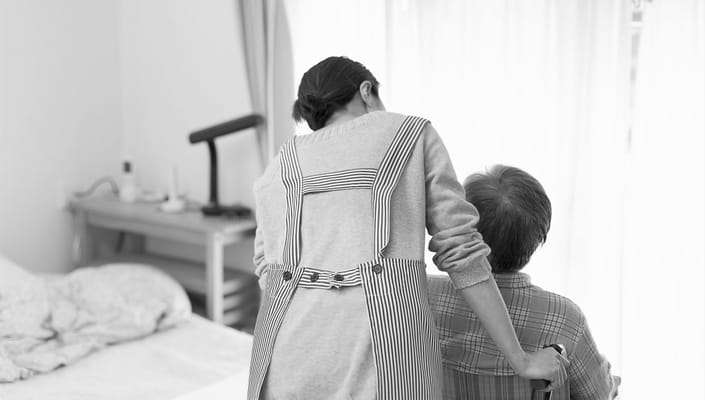 Staff assisting a resident in a caring environment