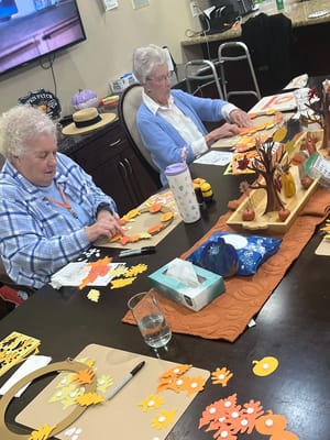 Residents engaged in a crafting activity at a table