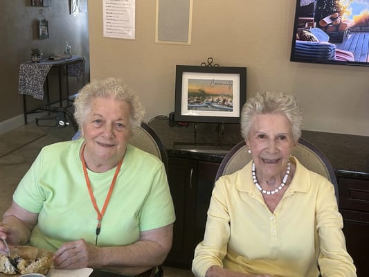 Two residents enjoying a meal together in a common area