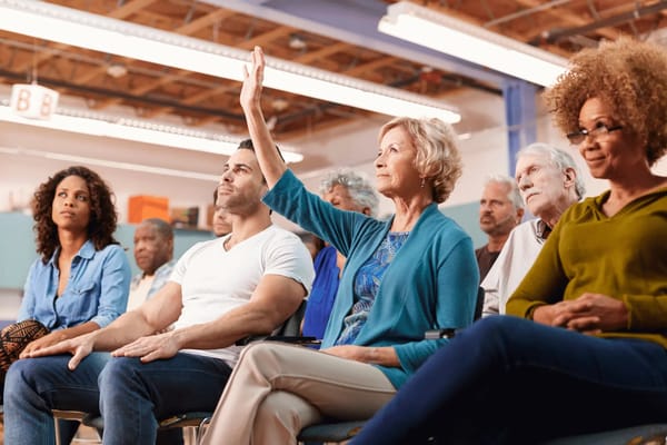 Residents engaged in a group discussion in a common area