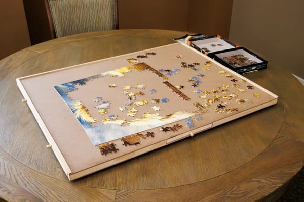 A jigsaw puzzle is in progress on a round table