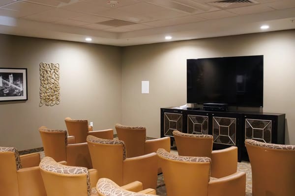 A cozy common area with seating and a television