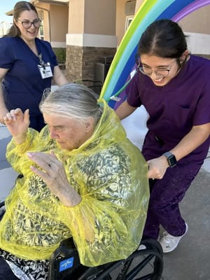 Residents being assisted by staff during an outdoor event