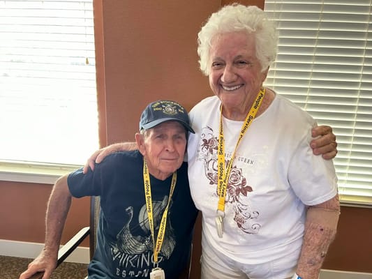Two smiling residents posing together indoors