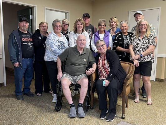 Group of residents and staff posing together in a common area