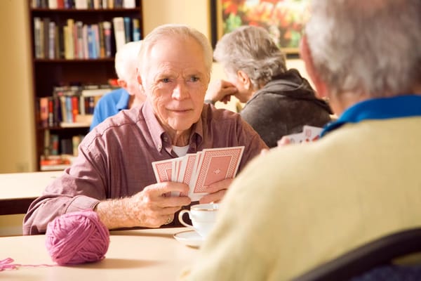 Residents playing cards in a common area