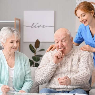 Residents engaging with a staff member in a cozy room