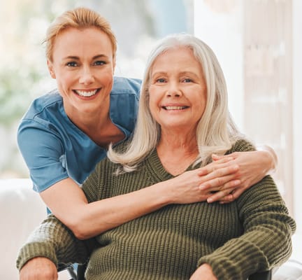A staff member and a happy resident posing together