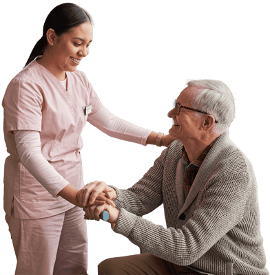 Caregiver assisting elderly man in a warm indoor setting