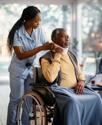 Nurse assisting a resident in a wheelchair