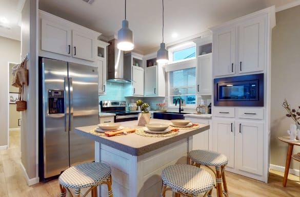 Modern kitchen interior with white cabinets and bar stools