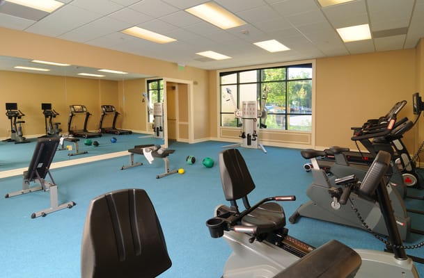 Fitness room with exercise equipment and mirrors