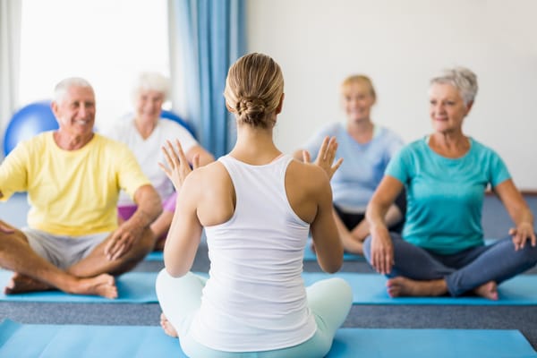 Residents participating in a yoga class with an instructor