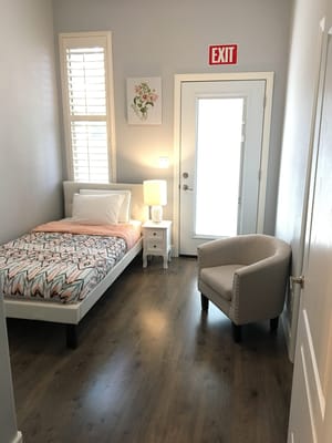 Cozy private resident room with a bed and lamp