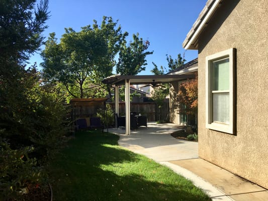 A sunlit outdoor space with seating and greenery