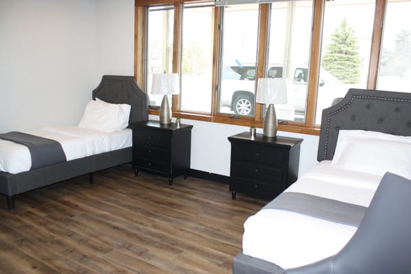 Brightly lit shared resident room with two beds