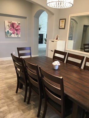 Bright dining area with a large table and decorative elements